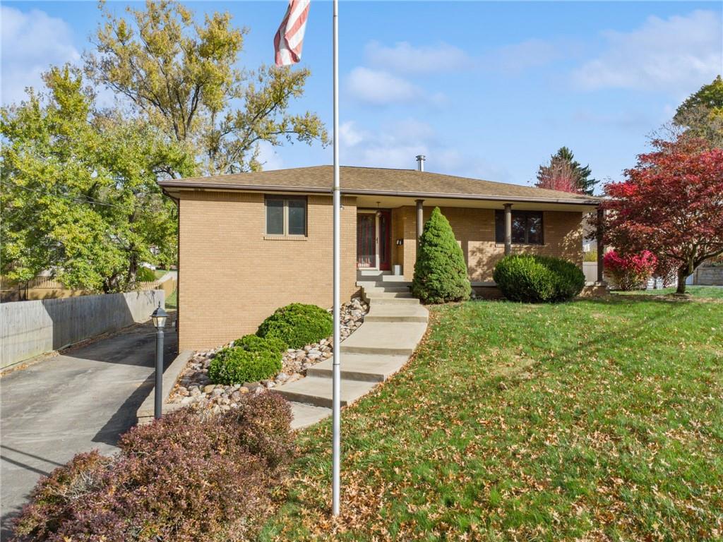 12219 Roth Drive Irwin, PA 15642 - Photo 6 of 49 a front view of a house with a yard and potted plants
