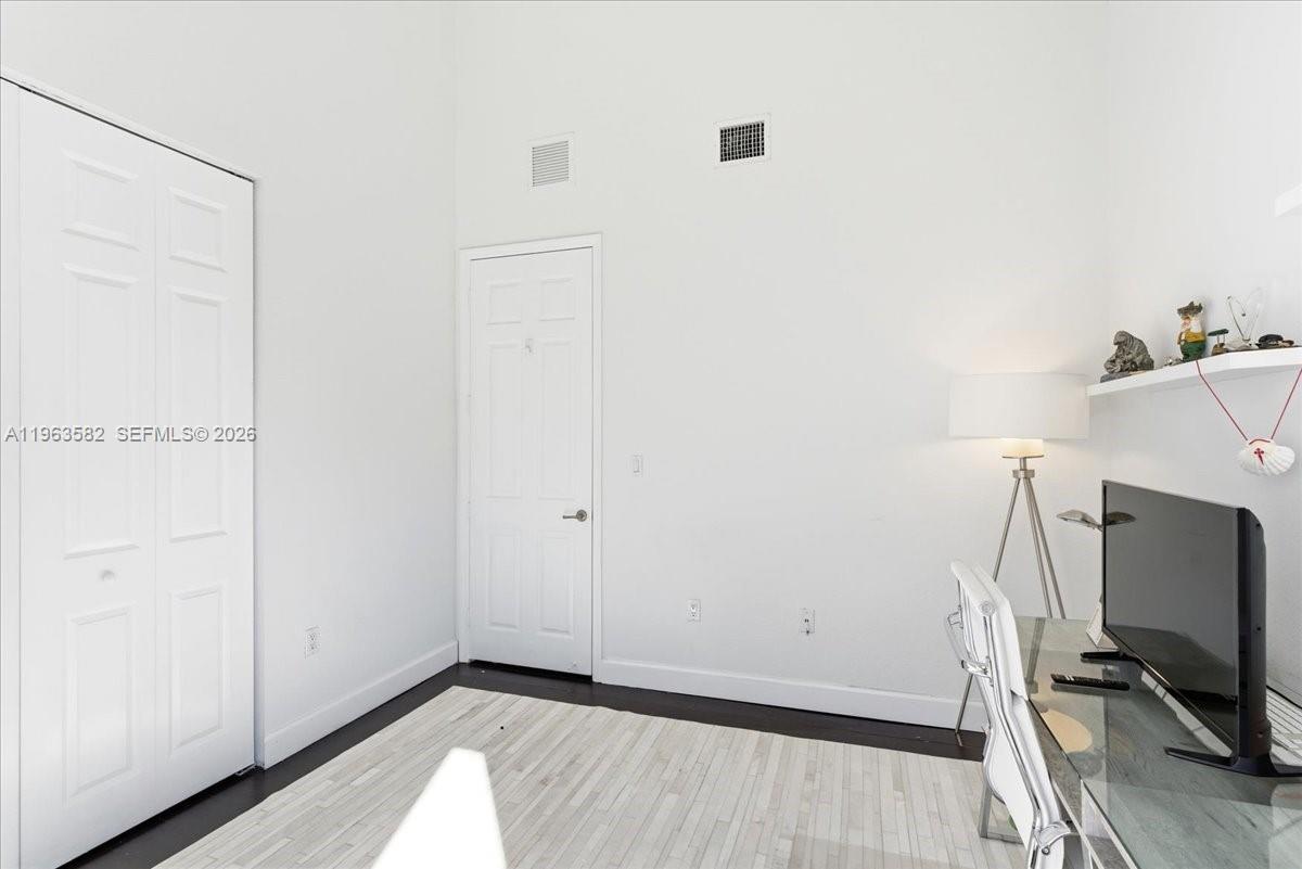 7743 Southwest 99th Street, Unit 2 Miami, FL 33156 - Photo 14 of 40 a view of room with wooden floor and flat screen tv