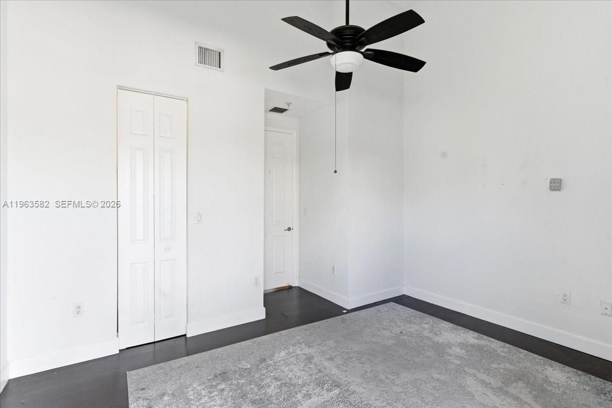 7743 Southwest 99th Street, Unit 2 Miami, FL 33156 - Photo 20 of 40 an empty room with a ceiling fan and a window