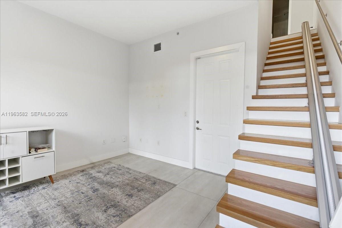 7743 Southwest 99th Street, Unit 2 Miami, FL 33156 - Photo 23 of 40 a view of a livingroom with wooden floor and entryway