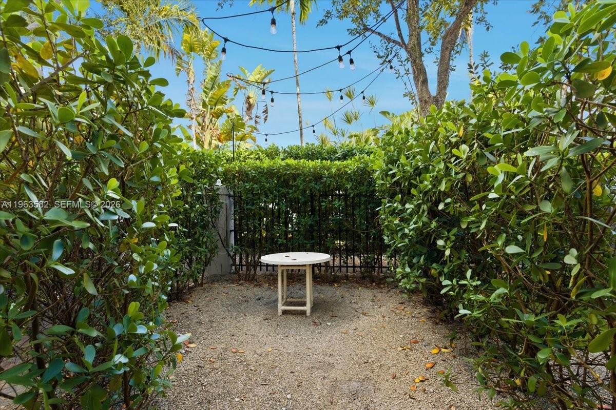 7743 Southwest 99th Street, Unit 2 Miami, FL 33156 - Photo 29 of 40 a lawn chair sitting in a backyard of a house