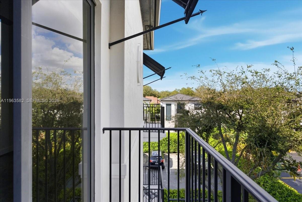 7743 Southwest 99th Street, Unit 2 Miami, FL 33156 - Photo 35 of 40 a view of a balcony with wooden floor