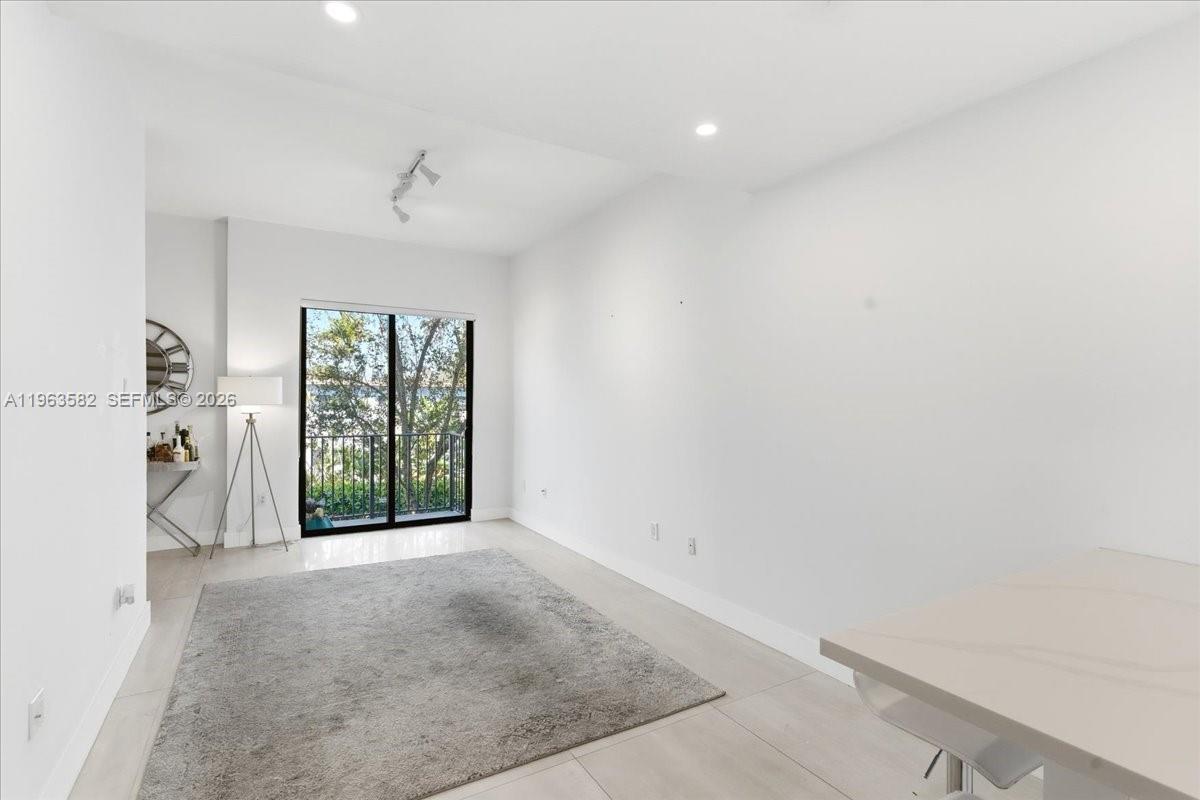7743 Southwest 99th Street, Unit 2 Miami, FL 33156 - Photo 8 of 40 wooden floor in an empty room with a window