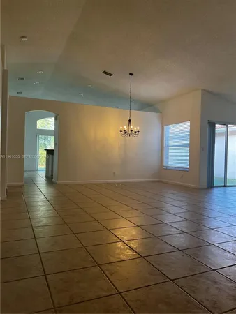 a view of a livingroom with an empty space and a window