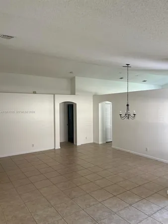 a view of a room with a ceiling fan