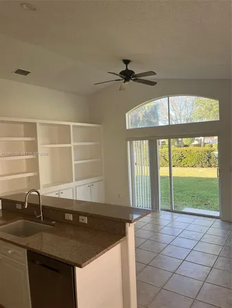 a kitchen with a sink a counter top space and cabinets