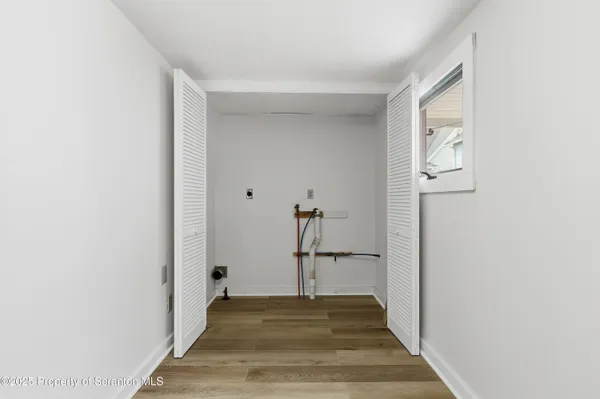 a view of a hallway view with wooden floor and staircase