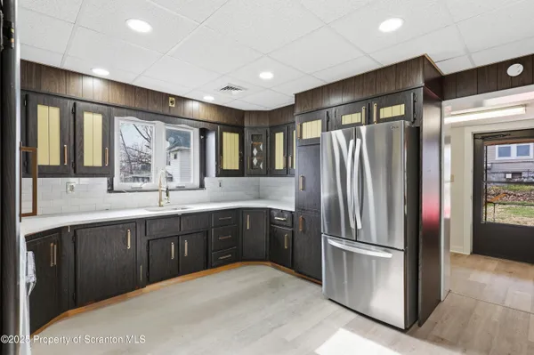 a kitchen with stainless steel appliances granite countertop a refrigerator and a sink