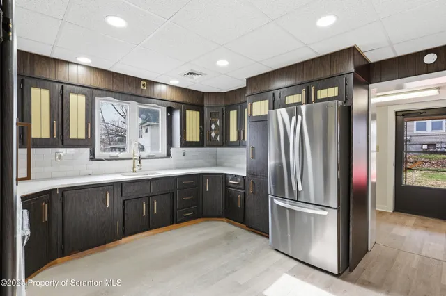 a kitchen with stainless steel appliances granite countertop a refrigerator and a sink
