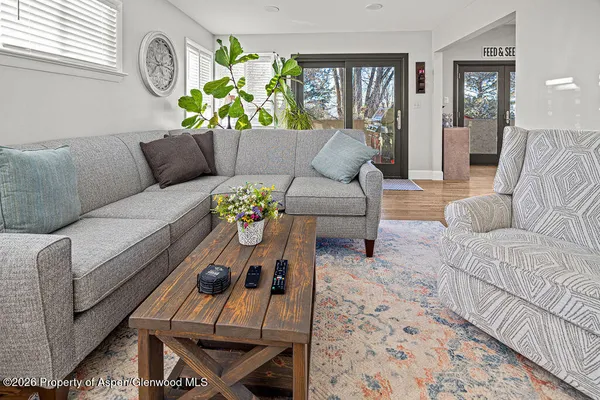 a living room with furniture and wooden floor