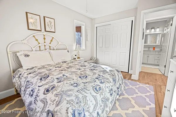 a bedroom with a large bed and a mirror