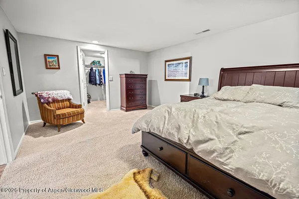 a bedroom with a bed dresser and a window