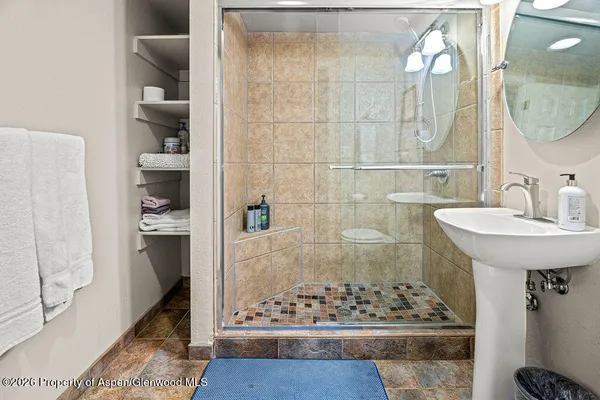 a bathroom with a sink a toilet and mirror