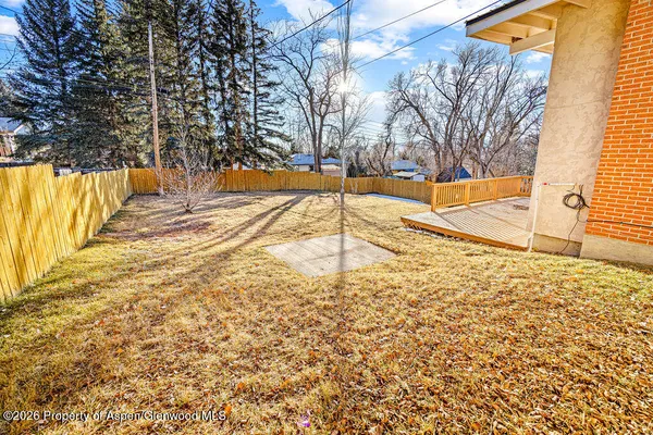 a view of a yard with yellow house