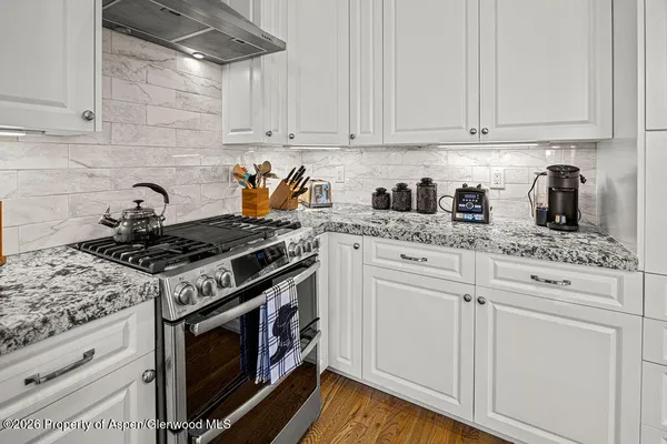 a kitchen with granite countertop cabinets and steel stainless steel appliances