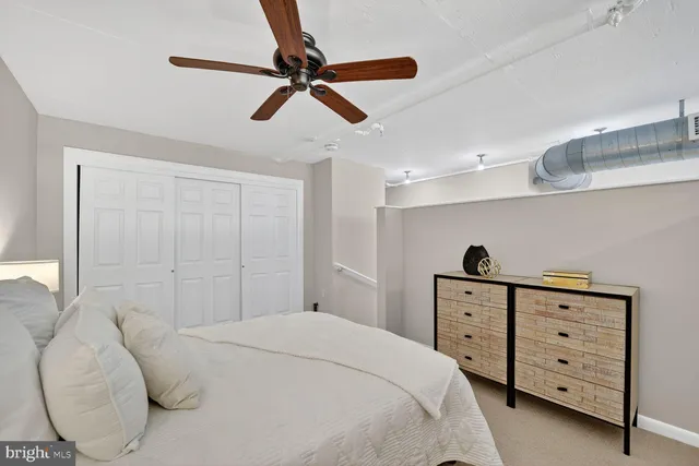 a bedroom with a bed and a dresser