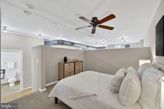a bedroom with a bed and a ceiling fan