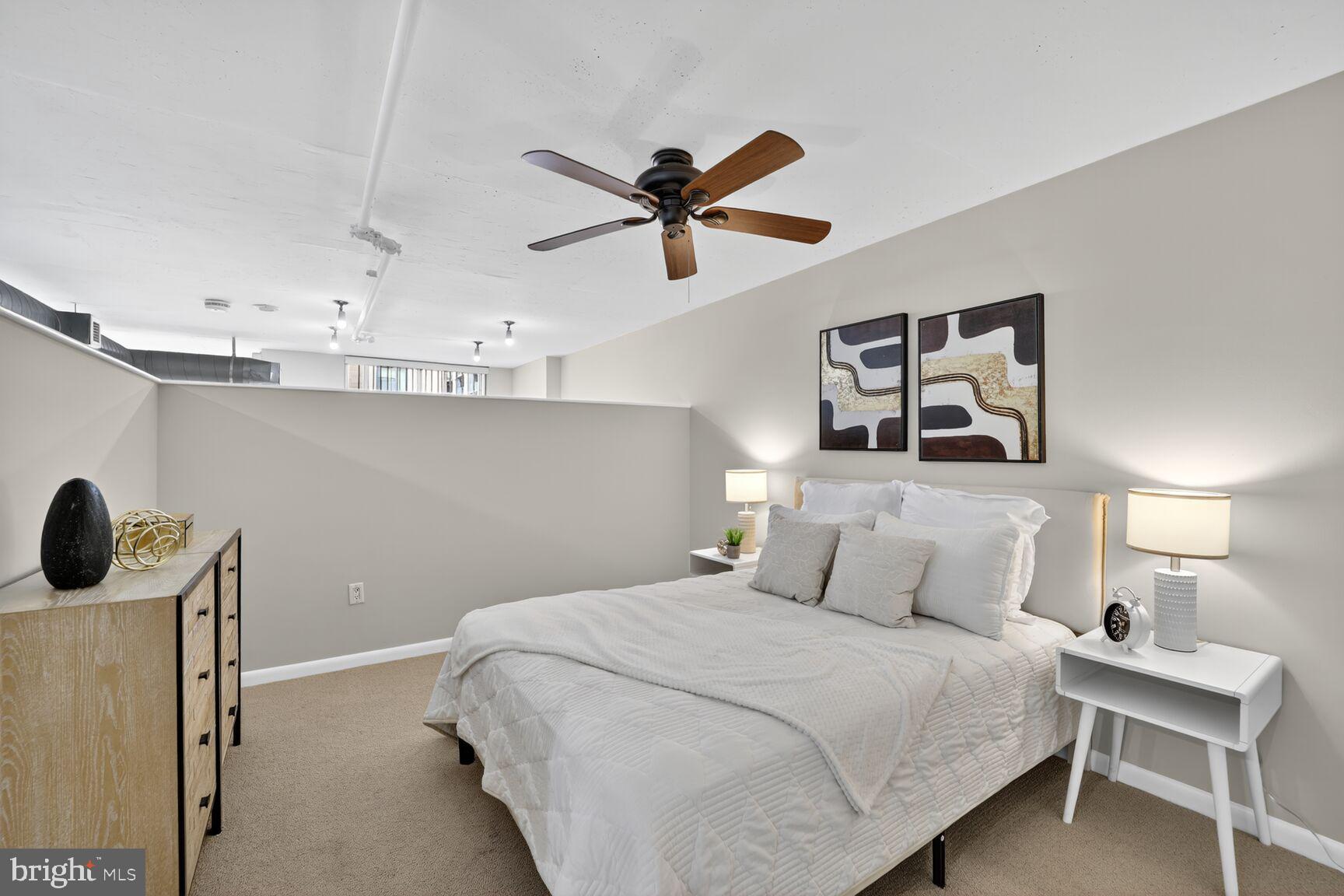 811 4th Street Northwest, Unit 807 Washington, DC 20001 - Photo 14 of 32 a bedroom with a bed and a window