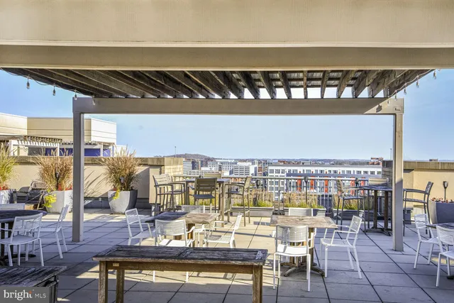 a view of a swimming pool with outdoor seating