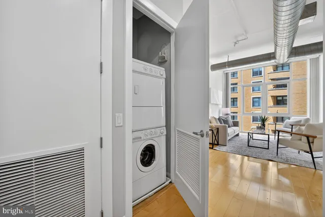 a view of a livingroom with furniture and floor to ceiling window