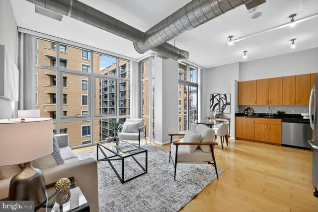 a living room with furniture and view of kitchen