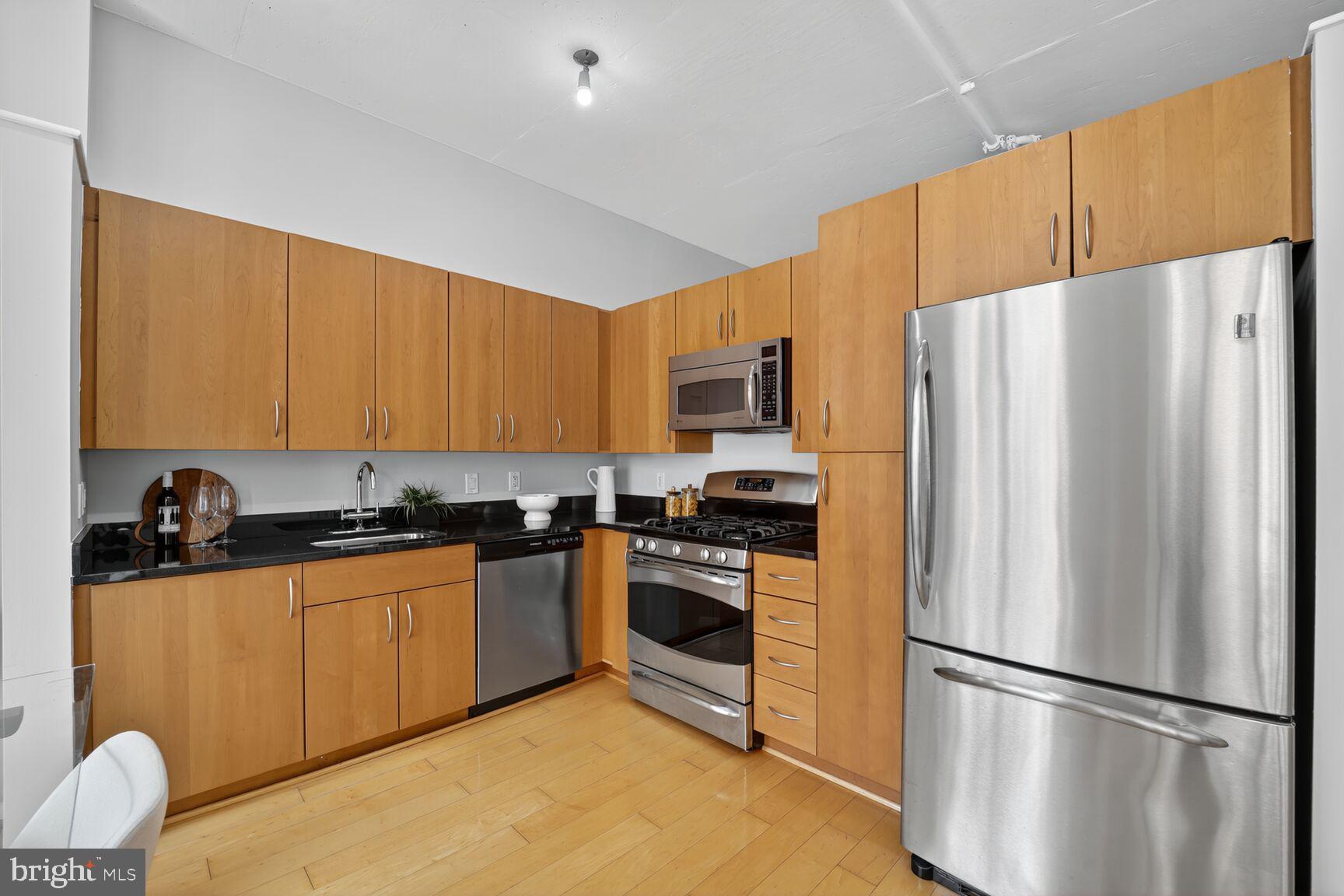 811 4th Street Northwest, Unit 807 Washington, DC 20001 - Photo 9 of 32 a kitchen with stainless steel appliances granite countertop a refrigerator stove a sink dishwasher and a refrigerator