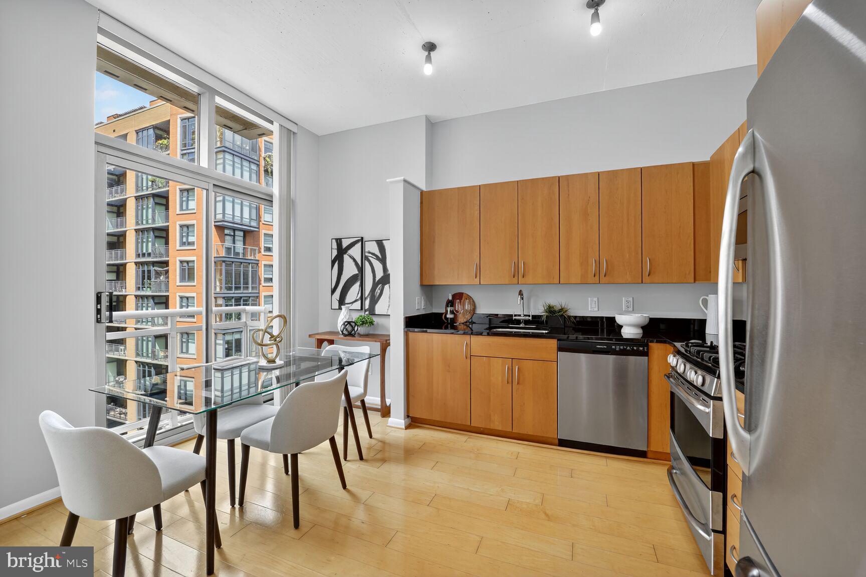 811 4th Street Northwest, Unit 807 Washington, DC 20001 - Photo 10 of 32 a kitchen with stainless steel appliances granite countertop a stove top oven a sink and a refrigerator
