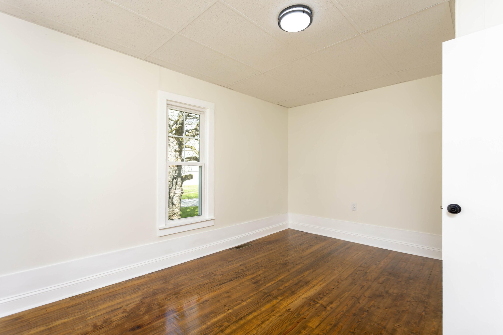 124 Gothard Road Sale Creek, TN 37373 - Photo 17 of 56 a view of an empty room with wooden floor and a window