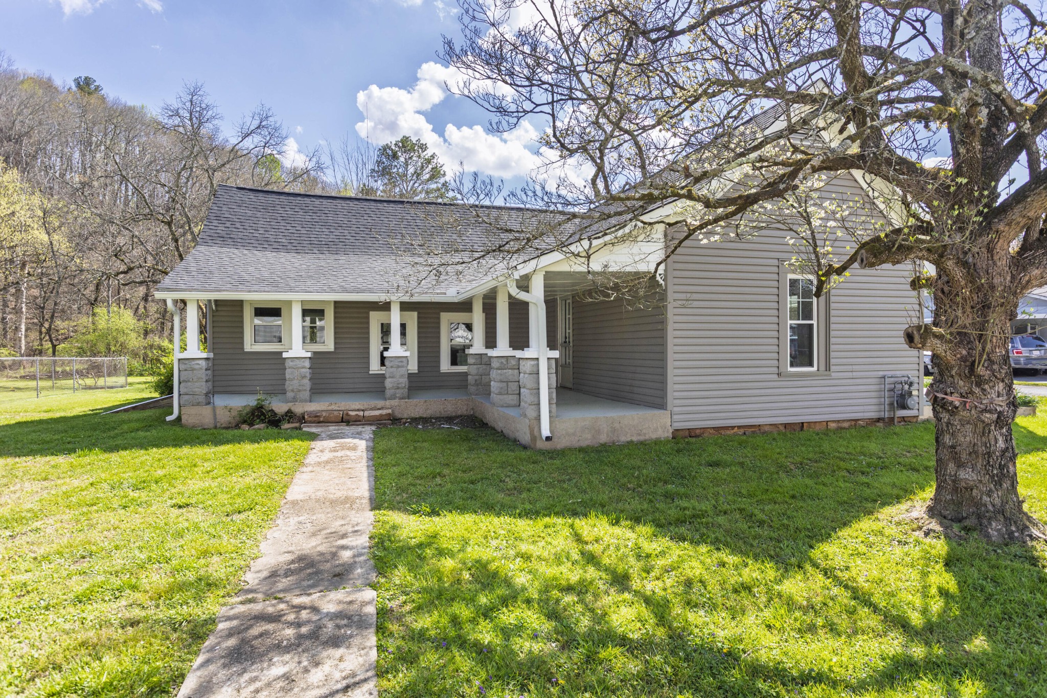 124 Gothard Road Sale Creek, TN 37373 - Photo 32 of 56 a front view of a house with yard patio and green space