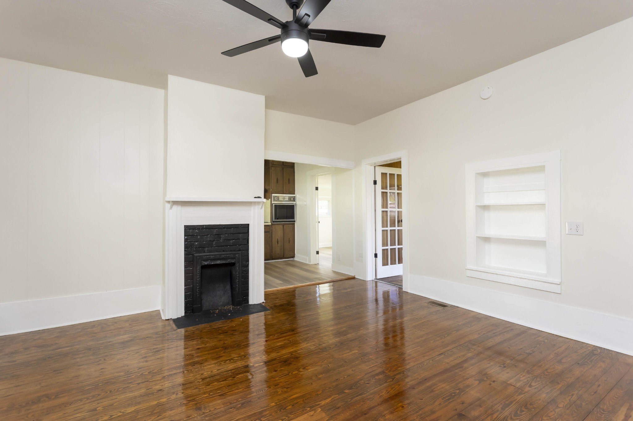 124 Gothard Road Sale Creek, TN 37373 - Photo 6 of 56 an empty room with wooden floor fireplace and windows