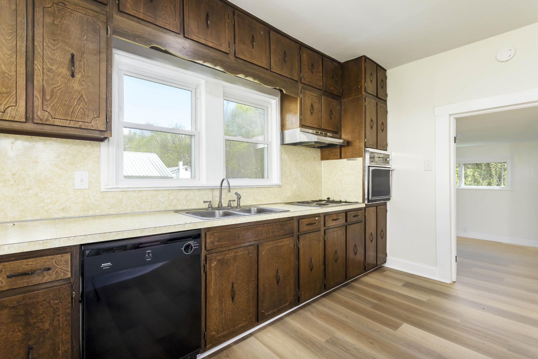 124 Gothard Road Sale Creek, TN 37373 - Photo 8 of 56 a kitchen with stainless steel appliances granite countertop a sink a stove and a wooden floors