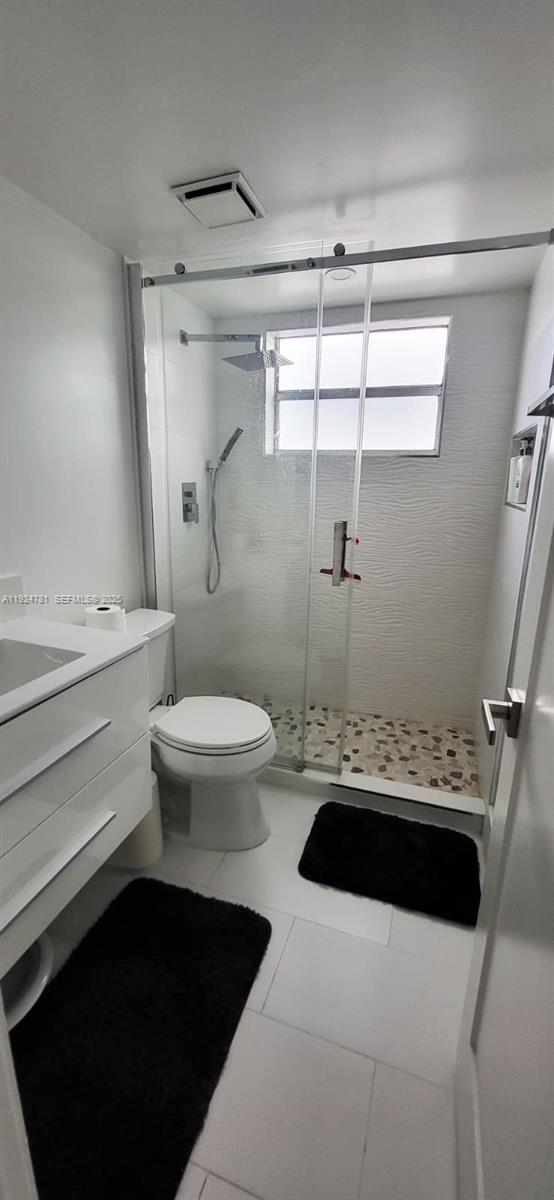 1605 Meridian Avenue, Unit 401 Miami Beach, FL 33139 - Photo 7 of 14 a bathroom with a sink a toilet and a shower