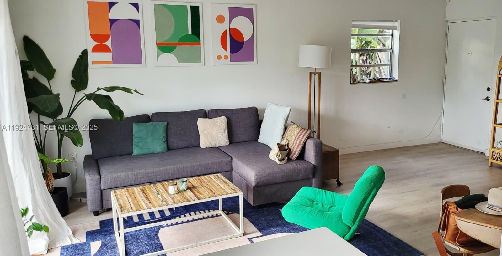 1605 Meridian Avenue, Unit 401 Miami Beach, FL 33139 - Photo 10 of 14 a living room with furniture and a wooden floor