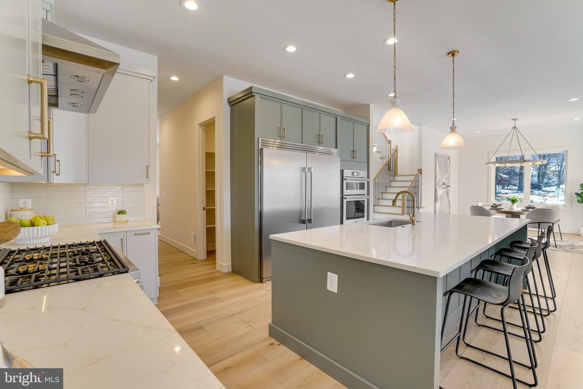 104 Dogwood Street Southwest Vienna, VA 22180 - Photo 6 of 13 a kitchen with stainless steel appliances granite countertop a sink a stove a refrigerator and island