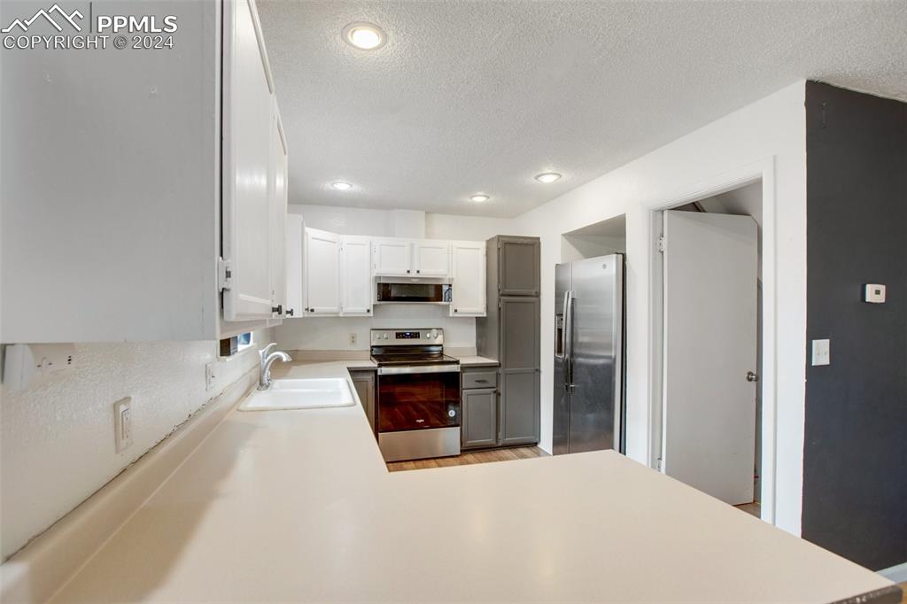 377 Ridge Road Divide, CO 80814 - Photo 20 of 50 a large kitchen with a large window and stainless steel appliances