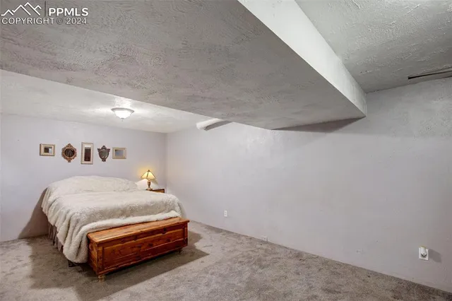 a bedroom with a bed and a night stand