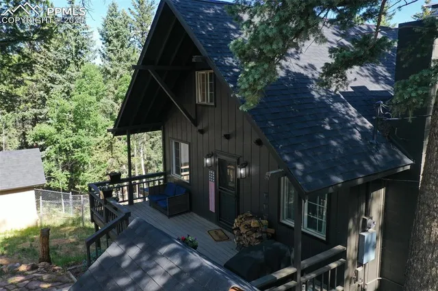 a black and white building with trees in the background