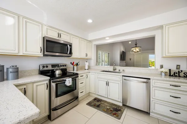 a kitchen with a sink stove and microwave