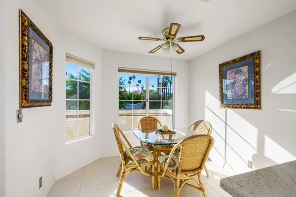 a view of a dining room with furniture and a window