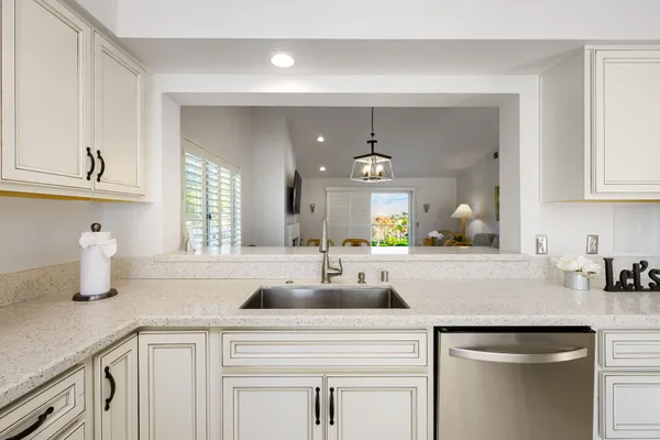 a kitchen with cabinets a sink and appliances