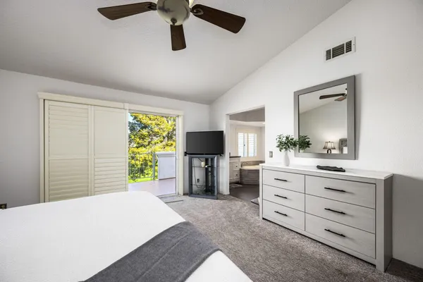 a bed room with a bed and a television