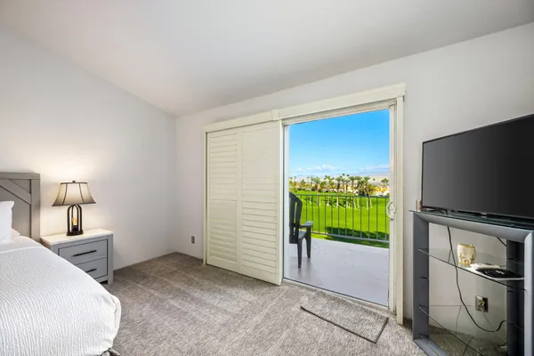a bedroom with furniture and a flat screen tv