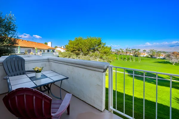 a view of a chairs and table in the patio