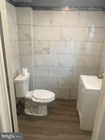 a toilet sitting in a bathroom next to a sink