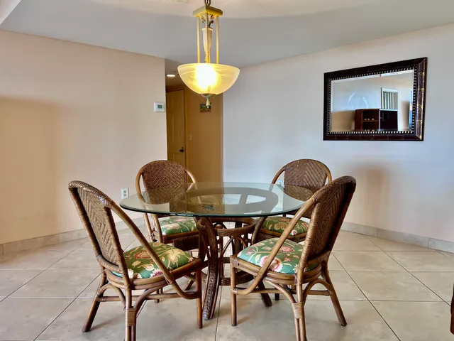 a dining room with furniture and chandelier