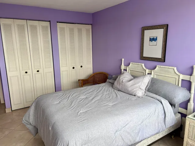 a bedroom with a bed and a closet