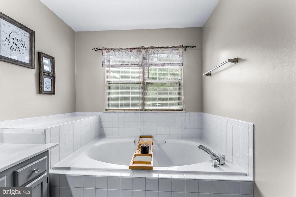 11409 Hermosa Drive Laurel, MD 20708 - Photo 18 of 28 a bath tub sitting in a bathroom next to a window