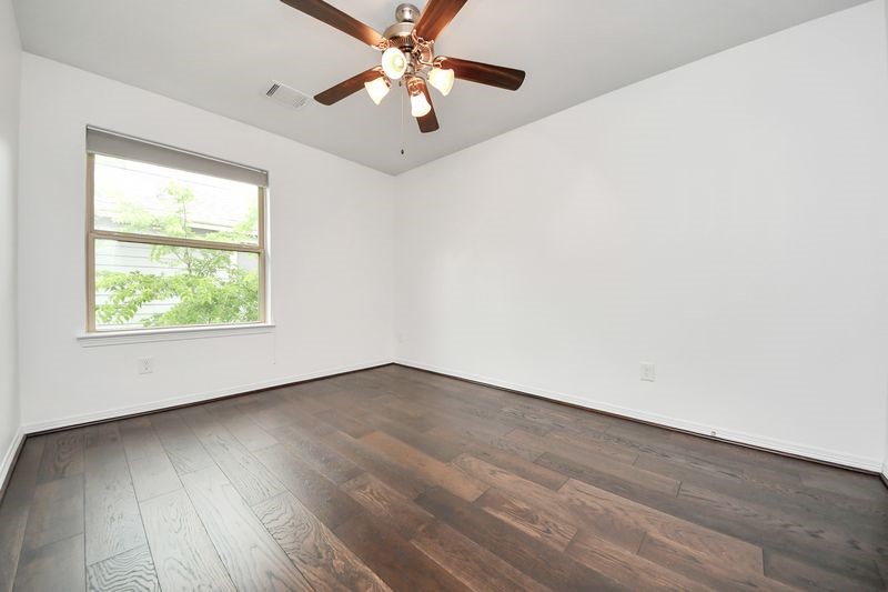 4222 Drake Street Houston, TX 77005 - Photo 23 of 28 an empty room with wooden floor fan and windows