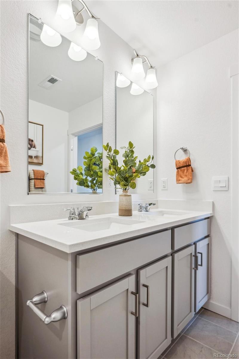 932 Logan Peak Way Berthoud, CO 80513 - Photo 18 of 34 a bathroom with a sink and a mirror