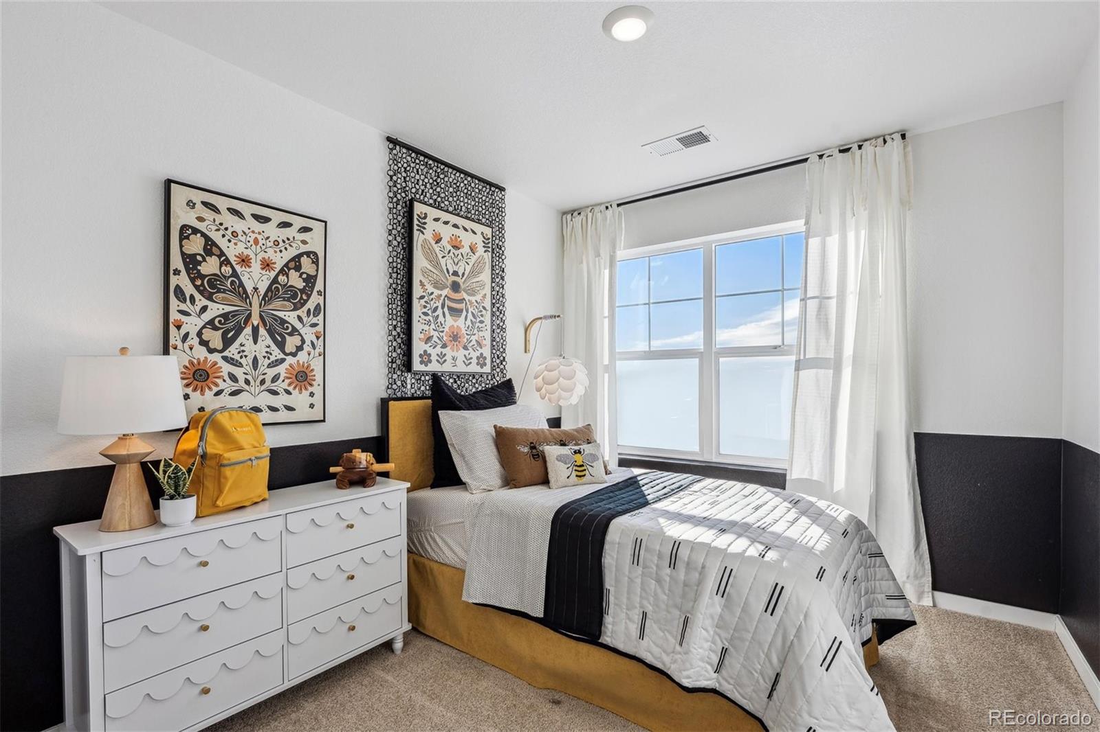 932 Logan Peak Way Berthoud, CO 80513 - Photo 19 of 34 a bedroom with a bed and wooden floor